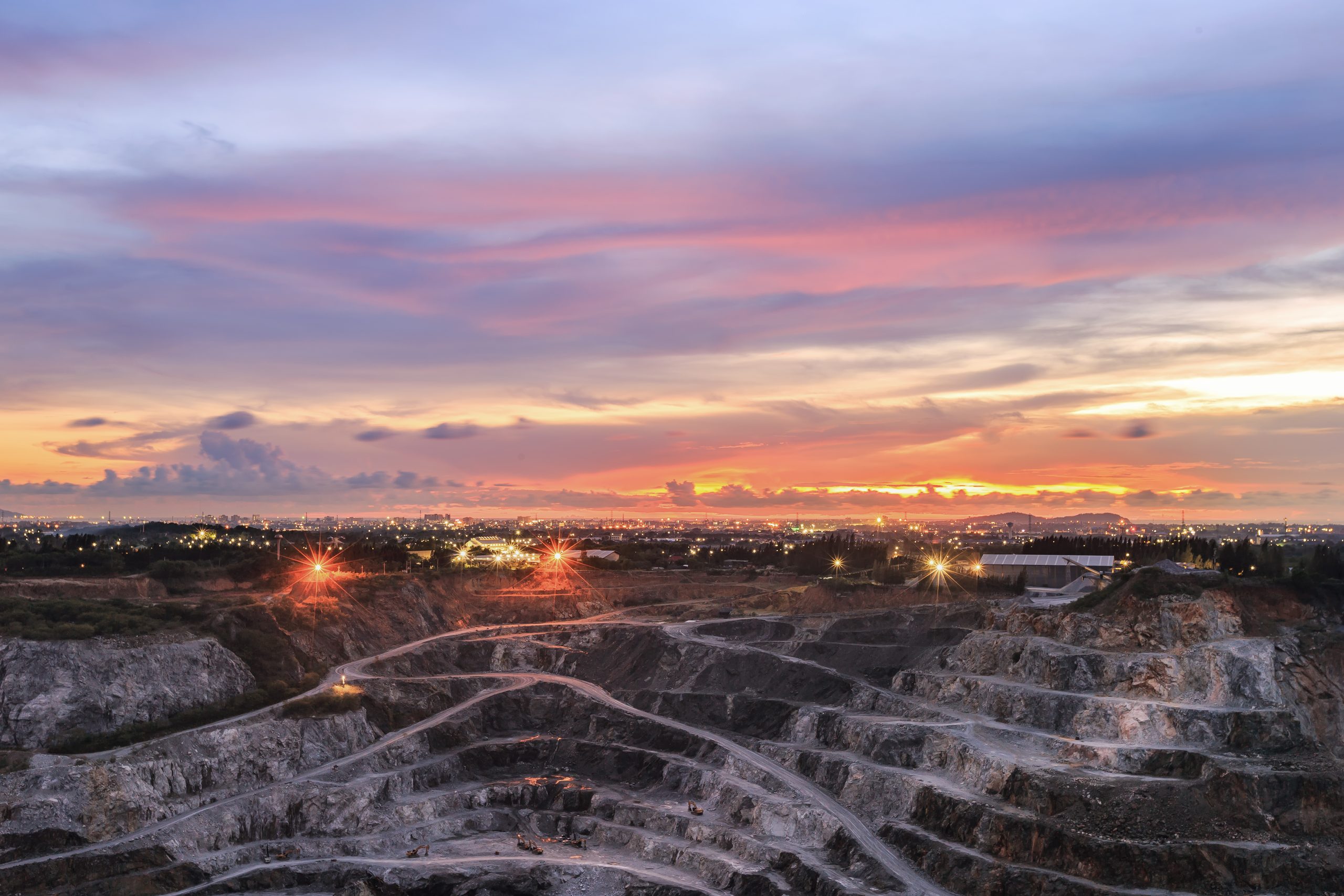 Aerial view of opencast mining quarry with lots of machinery at work